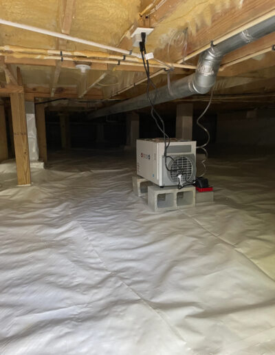 Crawl space that has been encapsulated with a dehumidifier